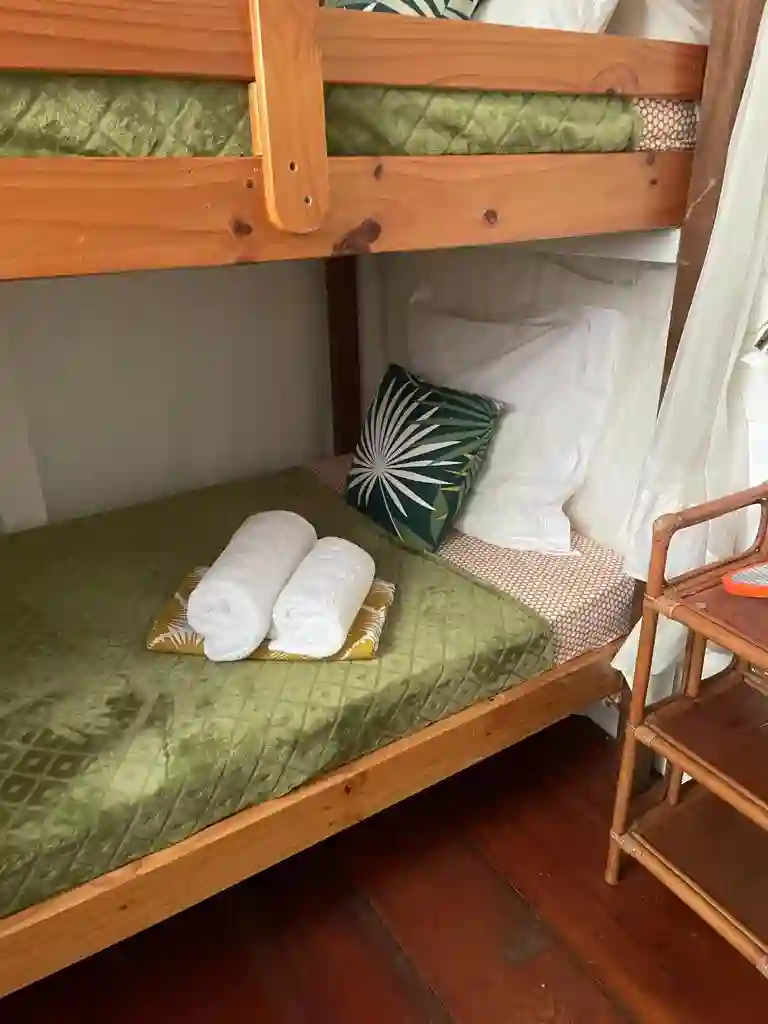 Cabin with two bunk beds, mosquito net, and air conditioning